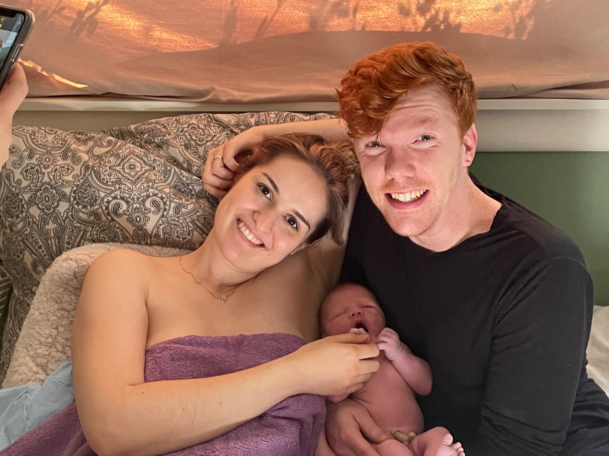 A man and woman holding a baby in their arms.