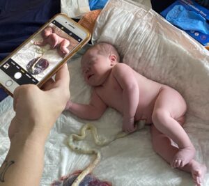 A person taking a picture of a baby